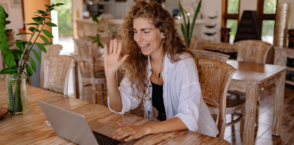 woman-laptop-waving-hello