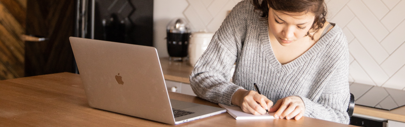 woman-writing-laptop-planning